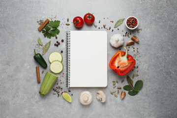 Blank recipe book and different ingredients on grey table, flat lay. Space for text