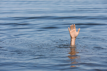 Drowning man reaching for help in sea, closeup