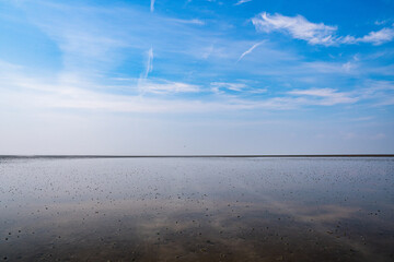 Beautiful wadden sea reflecting the blue sky on a warm sunny summer day at sahlenburg, cuxhaven