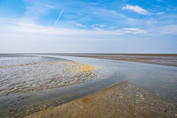 Small rivers floating through the mudflat of the north sea at sahlenburg, cuxhaven
