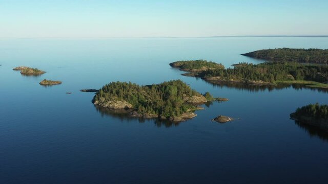 Aerial view on the lake and Islands with rocky coastline and forest in Karelia. Drone view on the beautiful Ladoga lake. Skerriy in the northwestern part of the Lake Ladoga
