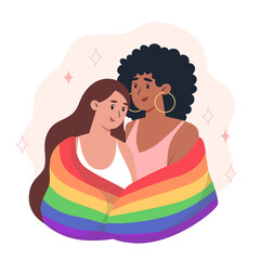 Young women couple hug each other and hold a rainbow LGBT pride flag