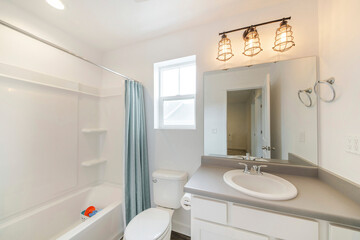 Small and simple bathroom interior with vanity and window