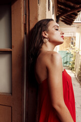 Portrait photo of a beautiful hispanic girl in a red dress with black long hair