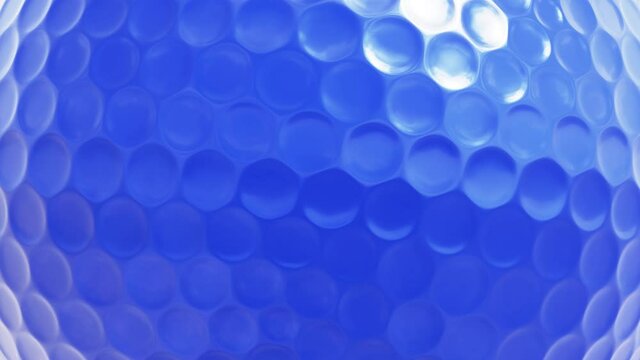 Realistic looping closeup view 3D animation of the spinning blue golf ball rendered in UHD as motion background