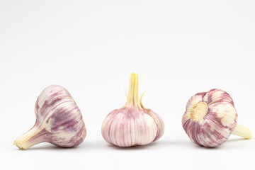 Three heads of garlic isolated on a white background.