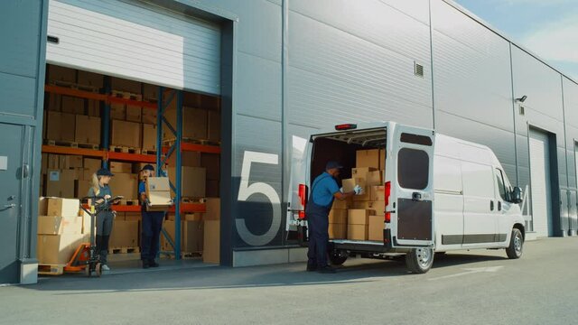 Outside of Logistics Retailer Warehouse With Manager Using Tablet Computer, Diverse Workers Loading Delivery Truck with Cardboard Boxes. Online Orders, Purchases, E-Commerce Goods. Wide Shot
