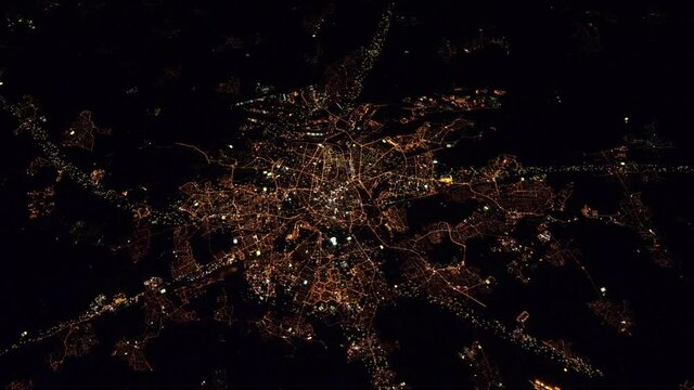 Night lights flying over city satellite aerial view of Munich, Germany Europe. Animation based on images furnished by Nasa