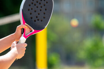 Woman playing beach tennis on a beach. Professional sport concept