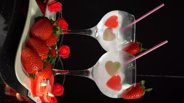 Floating cocktail in glasses and straw romantic Valentines Day 4k vertical video
