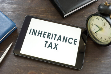 Inheritance tax words on the tablet and notepad.