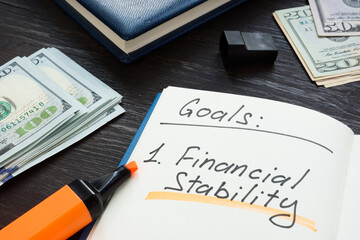 Written goals financial stability on the notepad page.