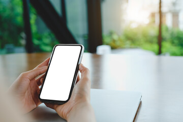 Close up of woman using cell phone,sending massages on the coffee shop with black screen,texting,video calls...