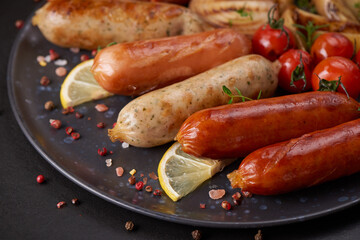 sausages and ingredients for cooking. Grilled sausage with the addition of herbs and and spices,...