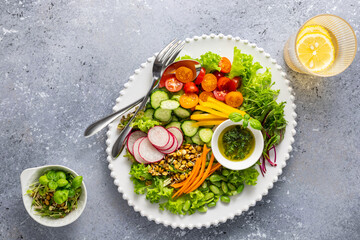 Healthy chopped salad with fresh vegetables, sprouts and sauce. Concept clean eating. Top view.