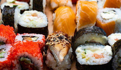 Closeup view on colorful set with sushi, maki and sashimi with raw salmon.