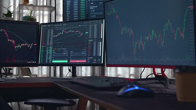 Stock Market Trader Multiple Computer Monitors With Financial Charts
