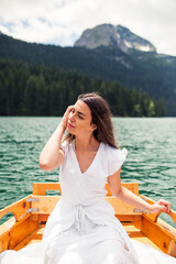 Young woman enjoying on boat at Black lake in Montenegro