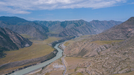 Aerial view of the Katun river flowing in a mountain gorge next to the highway, Altai photo by drone
