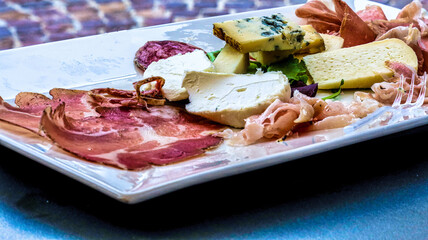 a platter of cold cuts and cheeses as an aperitif in Neive, in the Langhe