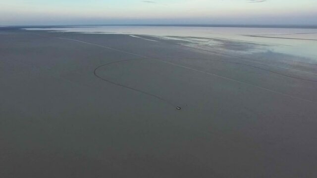 4x4 Car Stuck In A Salt Field After Heavy Rain In Makgadikgadi Pans, Botswana. Far Away From The Civilisation. Aerial Footage.