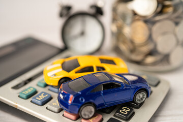 Obraz na płótnie Canvas Car and alarm clock on coins, Car loan, Finance, saving money, insurance and leasing time concepts.