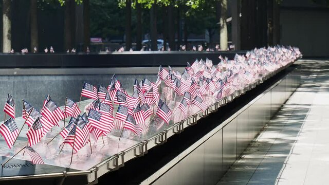 Close up shot of many America flags on the 911 Memorial South Pool