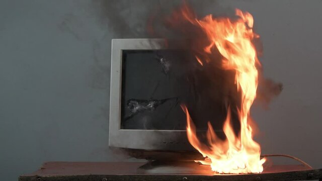The computer monitor is on fire, the fire spreads 