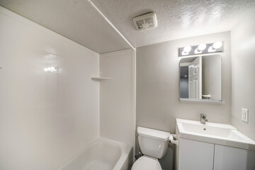 Fototapeta na wymiar Small all white bathroom interior with vanity sink and mirror