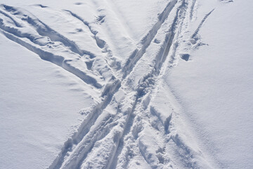 Fototapeta na wymiar Ski tracks on white snow, top view.