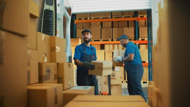 Outside of Logistics Distributions Warehouse: Two Happy Workers Load Delivery Truck with Cardboard Boxes, Then Deliver Online Orders, Purchases, E-Commerce Goods. Shot from Inside Van
