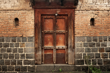 11 July 2021, Mharde, Satara, India, old vintage wooden door on retro wall