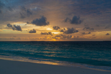 Fototapeta na wymiar breathtaking view of the gorgeous sky at sunset from the pestled beach of the Maldives island