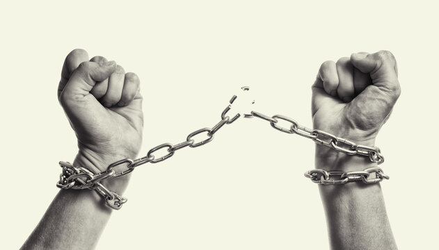 Man breaks the chains and gains freedom. The concept of gaining freedom. Black and white.