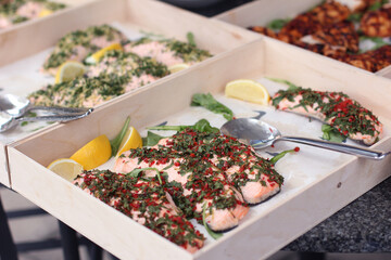 Seasoned Salmon with Lemon served in a catering box with lemon slices