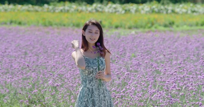 Happy young woman in flower field,4K
