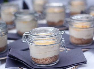 Lemon Cheesecake in jars on a catering table ready for a party 
