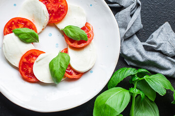 caprese salad mozzarella cheese, tomato meal snack copy space food background rustic. top view keto or paleo diet veggie vegan or vegetarian food