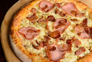 Sirloin and bacon pizza on a wooden board. Brazilian pizza.