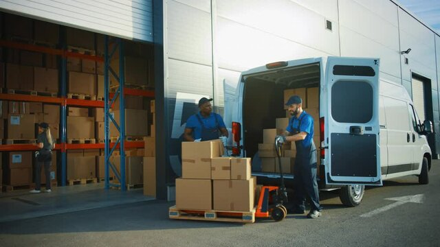 Outside of Logistics Distributions Warehouse: Two Workers Talk, Joke use Hand Pallet Truck Start Loading Delivery Truck with Cardboard Boxes, Online Orders, Purchases, E-Commerce Goods. Wide Pan