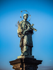 Fototapeta na wymiar Bronze Statue of Saint John of Nepomuk or Jan Nepomucky on Charles Bridge in Prague, Czech Republic