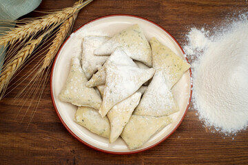 Dumplings. Product for eating or freezing, cooking process. Raw dough stuffed. The concept of semi-finished products.