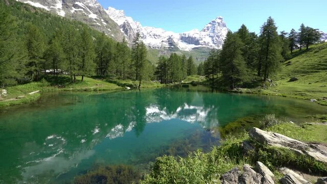 Idyllic morning view at the Blue Lake with the Matterhorn reflecting on the water, Valtournenche, Aosta Valley, Italy.