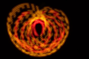 Abstract: Colorful Swirls of Light Creating Butterfly Pattern on a Black Background