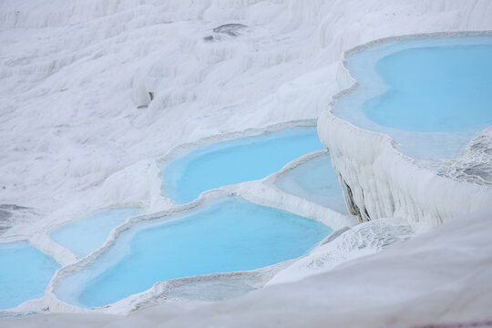 Natural travertine pools and terraces in Pamukkale. Cotton castle in southwestern Turkey. Pamukkale travertine and ancient city of Hierapolis. turquoise water travertine pools at pamukkale