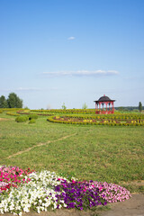 Park with gazebo flowers and grass in summer