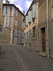In the heart of the city, narrow, cobbled lane, with stone walls, old wooden shutters