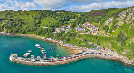 Aerial Drone image of Bonne Nuit Harbour in the sunshine at high tide. Jersey, Channel Islands