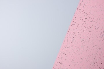 Christmas grey and pink minimal background with confetti. Flat lay, copy space