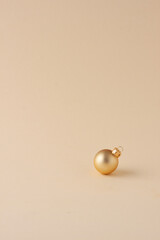 Christmas pastel beige minimal background with beige ball. Close up, copy space